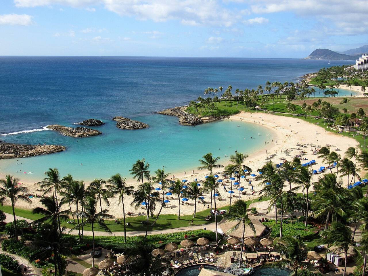 Ko Olina's calm lagoon ringed by palms and white sand