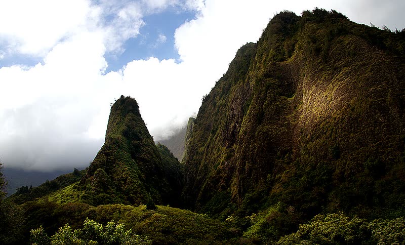 The green spire of the ʻĪao Needle rises from the lush, steep walls of ʻĪao Valley.
