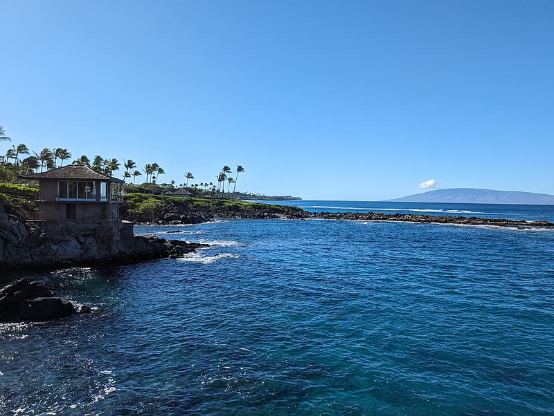Blue water and rocky shoreline at Namalu Bay along the Kapalua Coastal Trail.