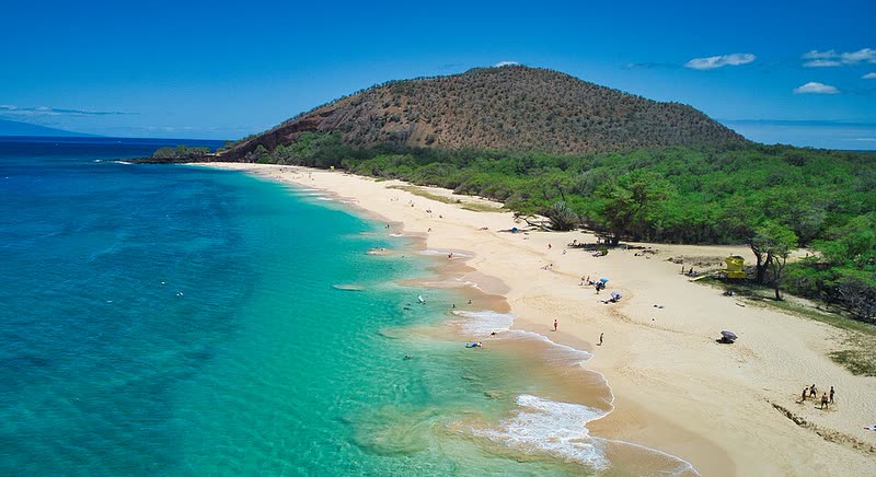 Aerial view of the long golden sand and turquoise water of Mākena's Big Beach.