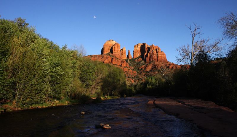 Cathedral Rock's red sandstone spires above juniper-covered slopes in Sedona